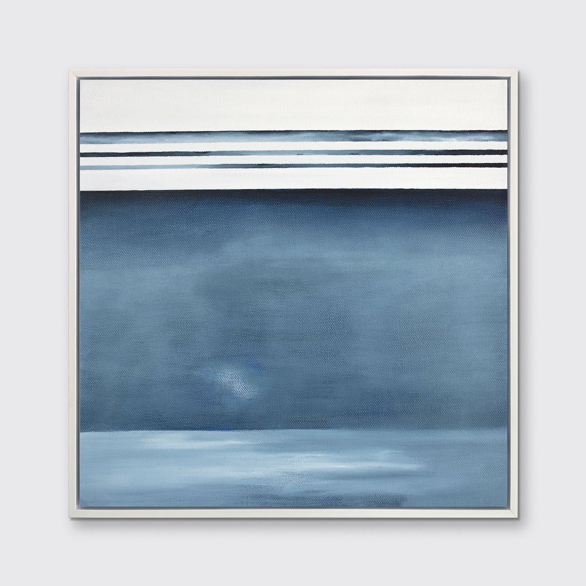 A blue and white abstract print in a white floater frame hangs on a white wall.