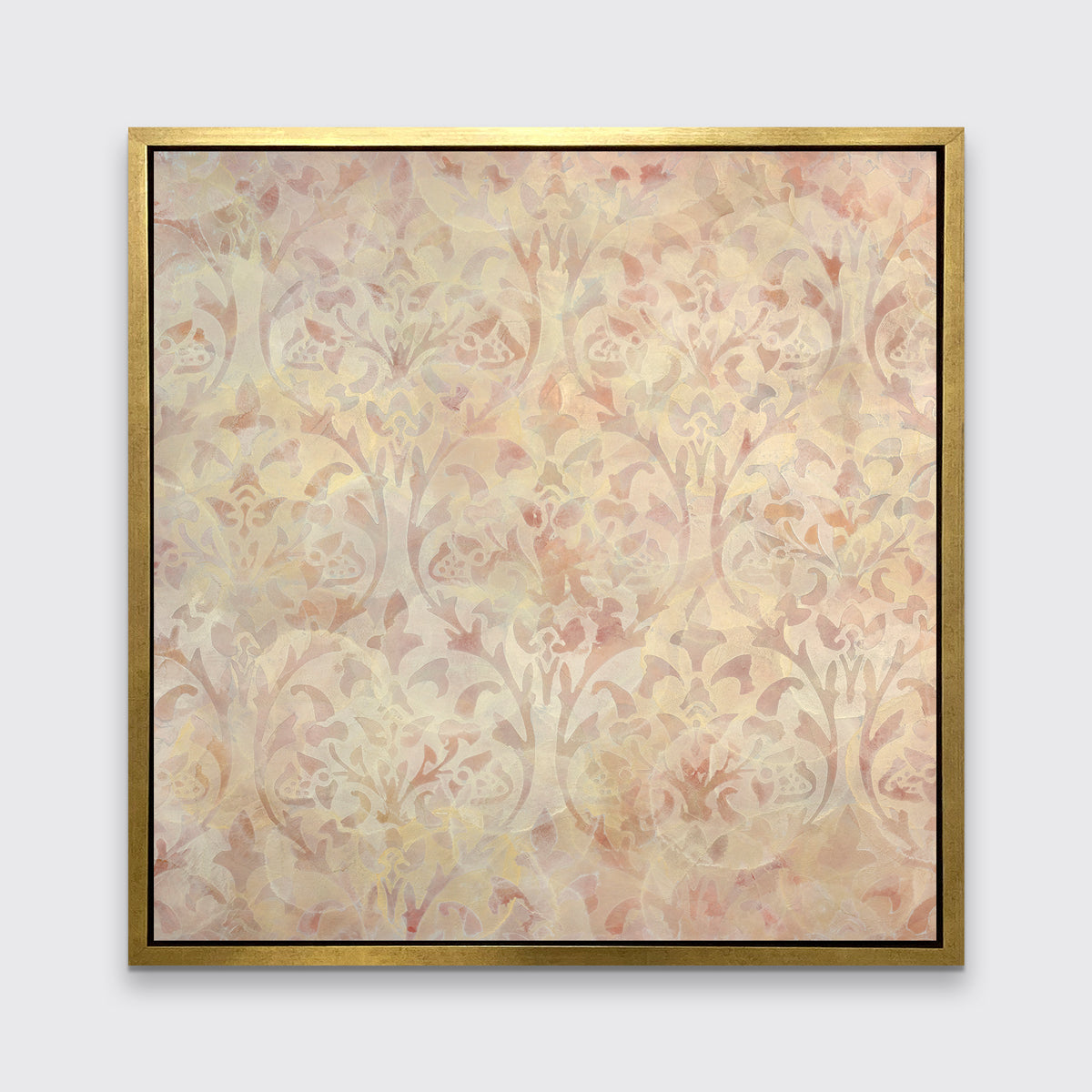 A pale pink and pale yellow abstract print in a gold floater frame hangs on a white wall.