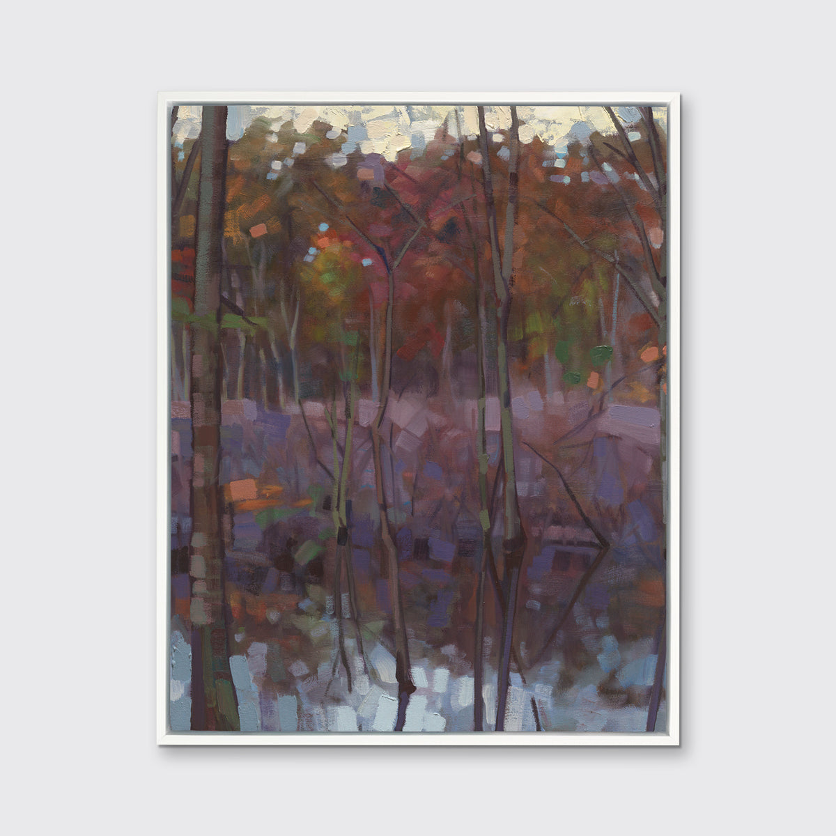 A muted multicolored abstract landscape print in a white floater frame hangs on a white wall.