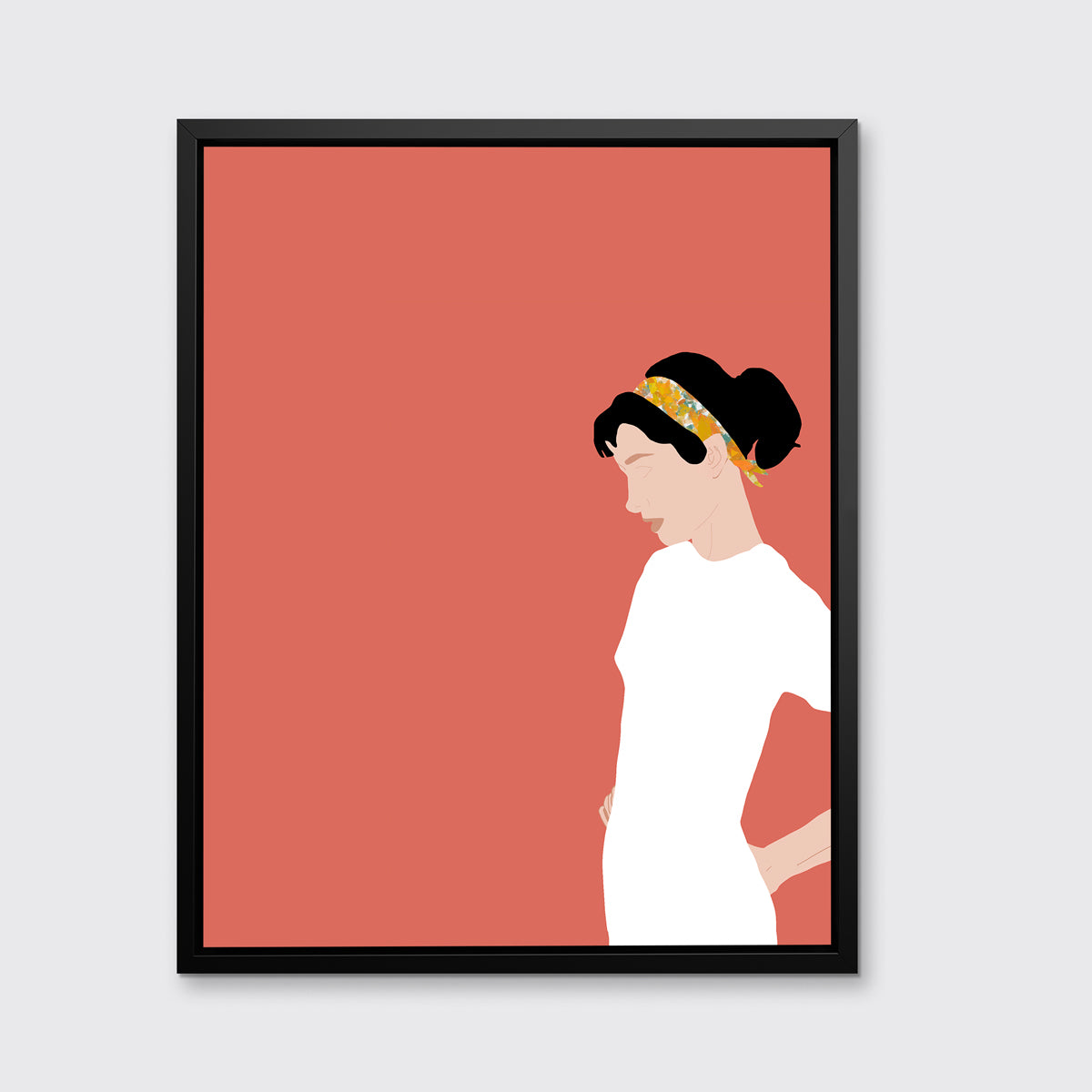 A print with a woman in a white dress and pink background, framed in a black floater frame on a grey wall.