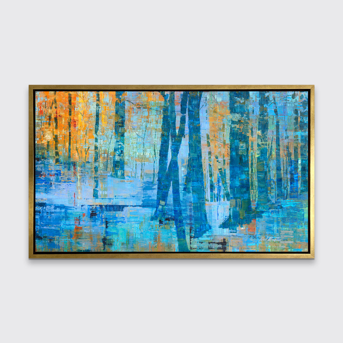 A blue, green and orange abstract tree landscape print in a gold floater frame hangs on a white wall.