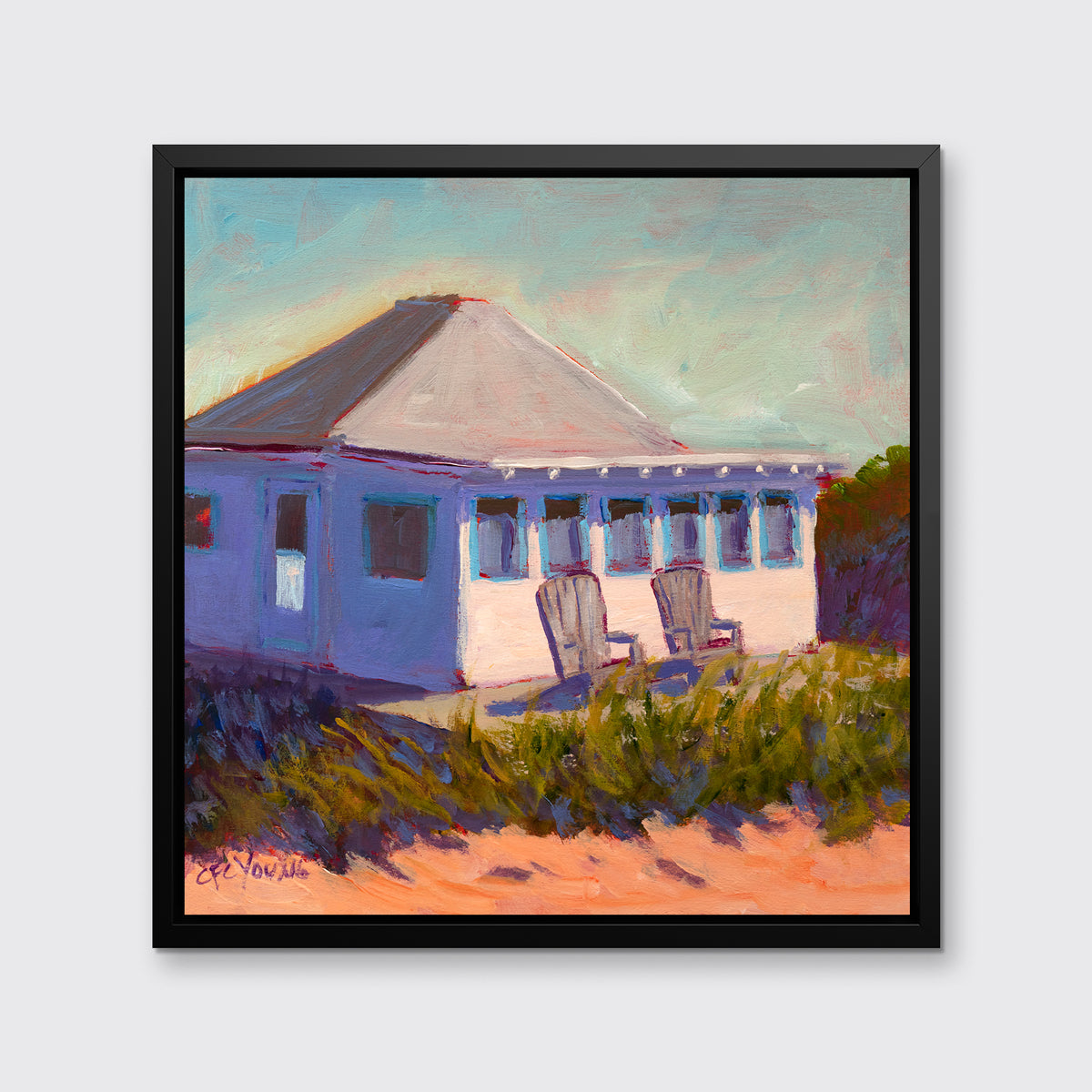 A teal, lavender, beige and green contemporary cottage print with adirondack chairs in a black floater frame hangs on a white wall.