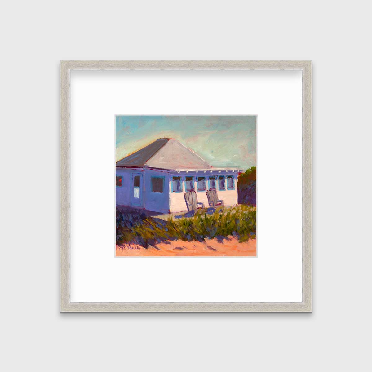A teal, lavender, beige and green contemporary cottage print with adirondack chairs in a silver frame with a mat hangs on a white wall.