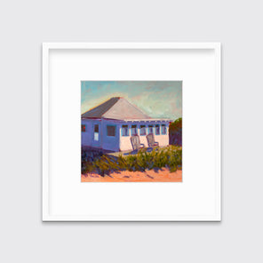 A teal, lavender, beige and green contemporary cottage print with adirondack chairs in a white frame with a mat hangs on a white wall.