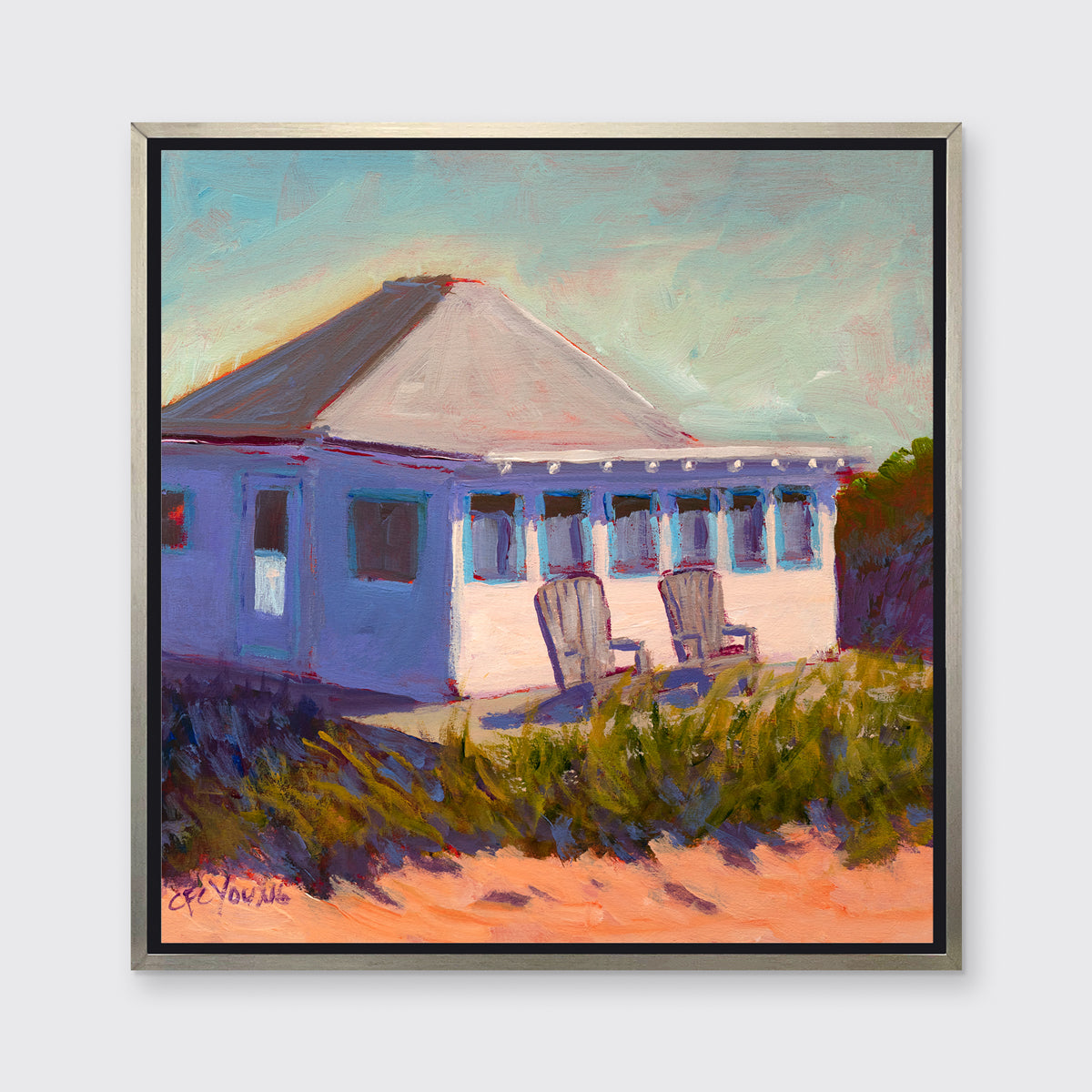 A teal, lavender, beige and green contemporary cottage print with adirondack chairs in a silver floater frame hangs on a white wall.