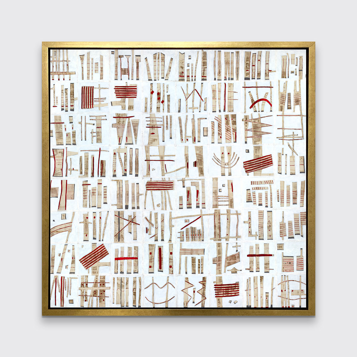 A white, beige and red abstract print in a gold floater frame hangs on a white wall.