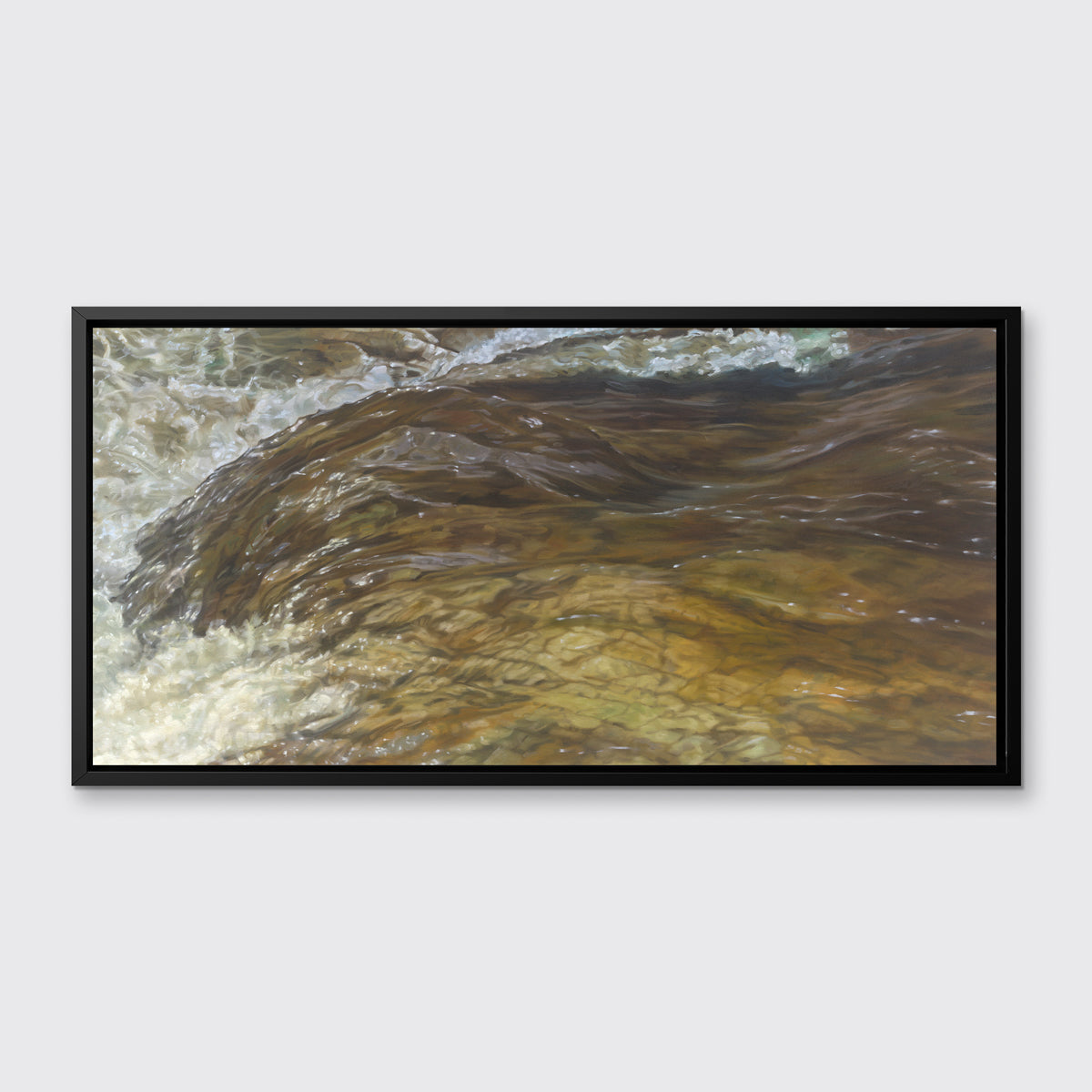 A brown, beige and white abstract river print in a black floater frame hangs on a white wall.