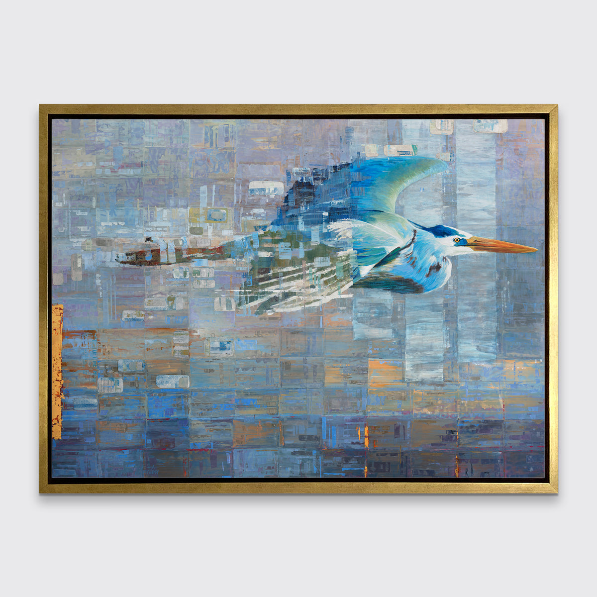 A blue, teal and light purple geometric abstract print of a blue heron in mid-flight with gold accents in a gold floater frame hangs on a white wall.