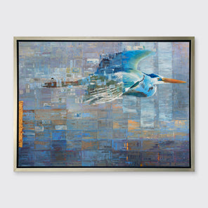 A blue, teal and light purple geometric abstract print of a blue heron in mid-flight with gold accents in a silver floater frame hangs on a white wall.