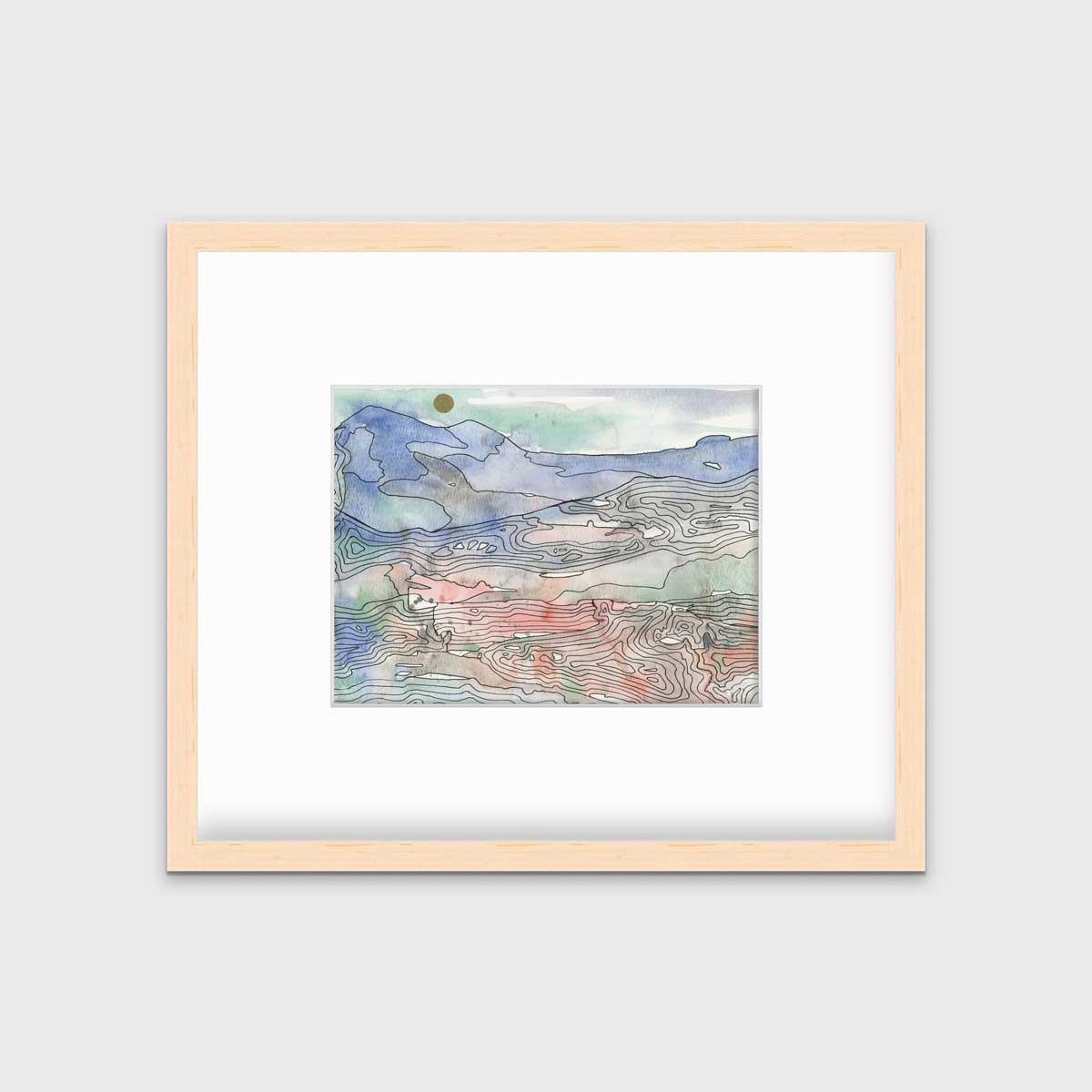 A blue, green and red abstract landscape print in a natural wood frame with a mat hangs on a white wall.
