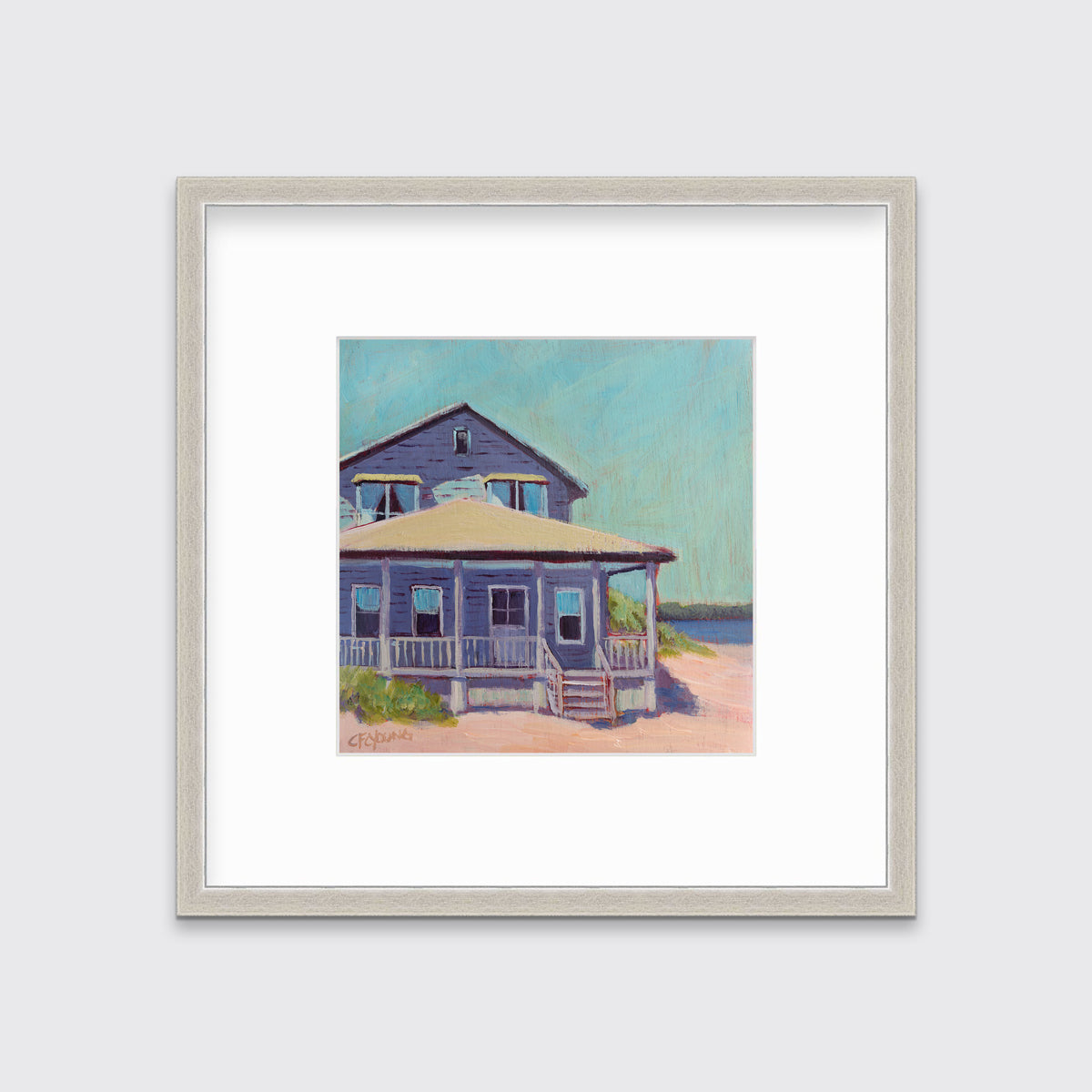A teal, purple, beige and rose contemporary beach house print in a silver frame with a mat hangs on a white wall.