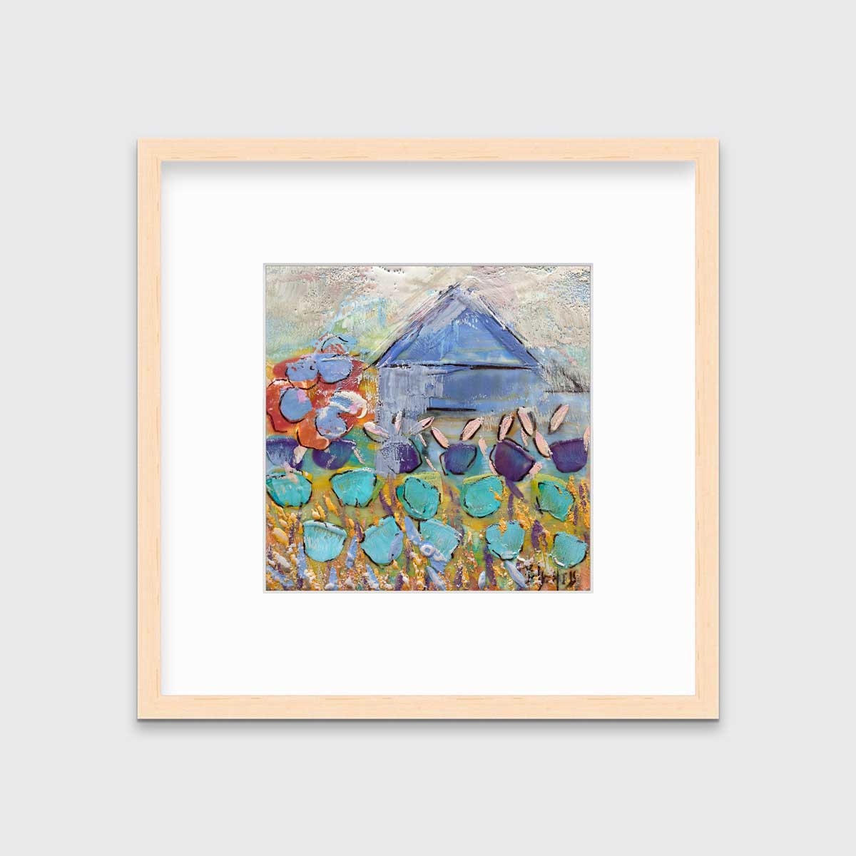 A teal, green and white abstract floral print in a natural wood frame with a mat hangs on a white wall.