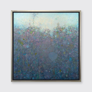 A blue and purple abstract landscape print in a silver floater frame hangs on a white wall.