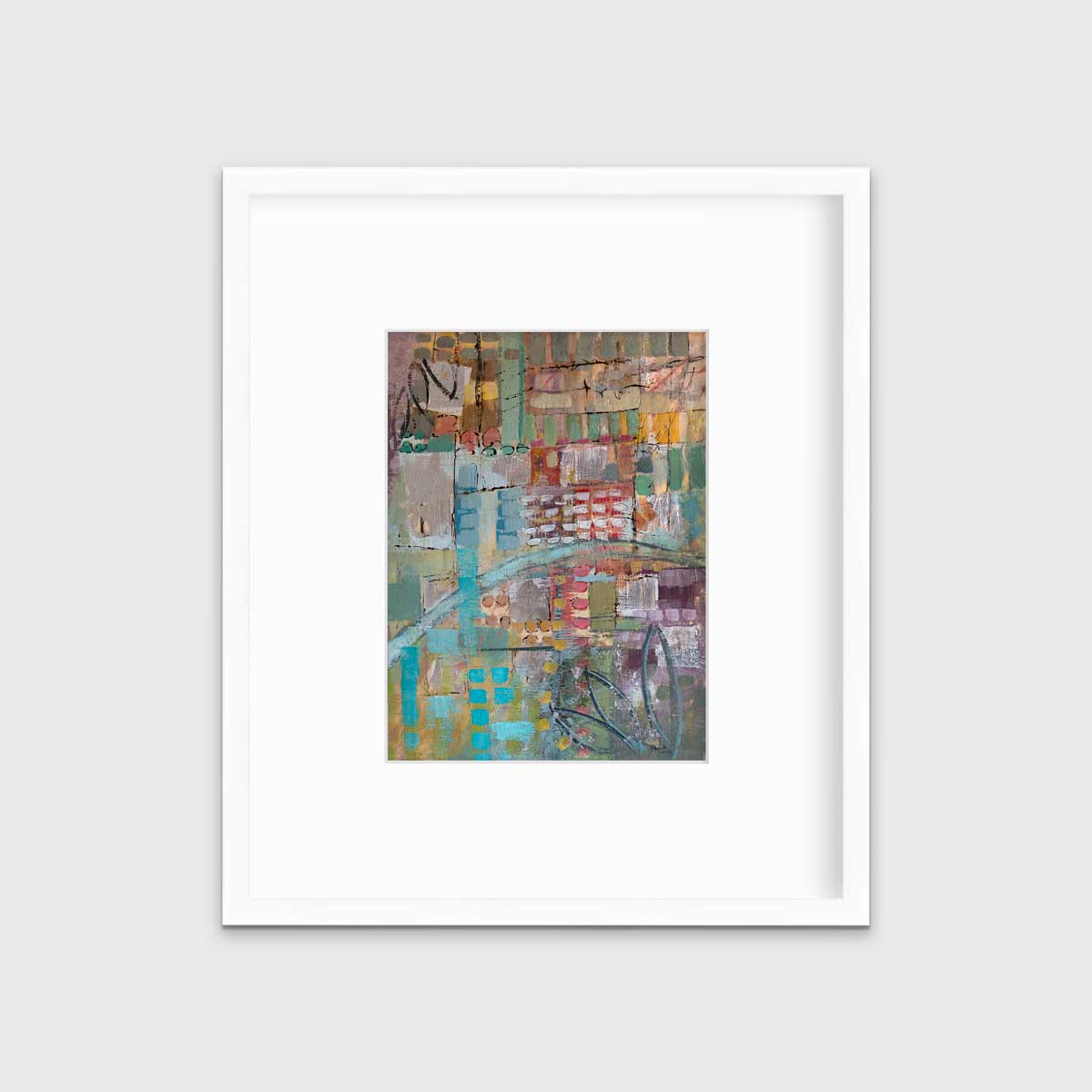 A multicolored abstract print in a white frame with a mat hangs on a white wall.