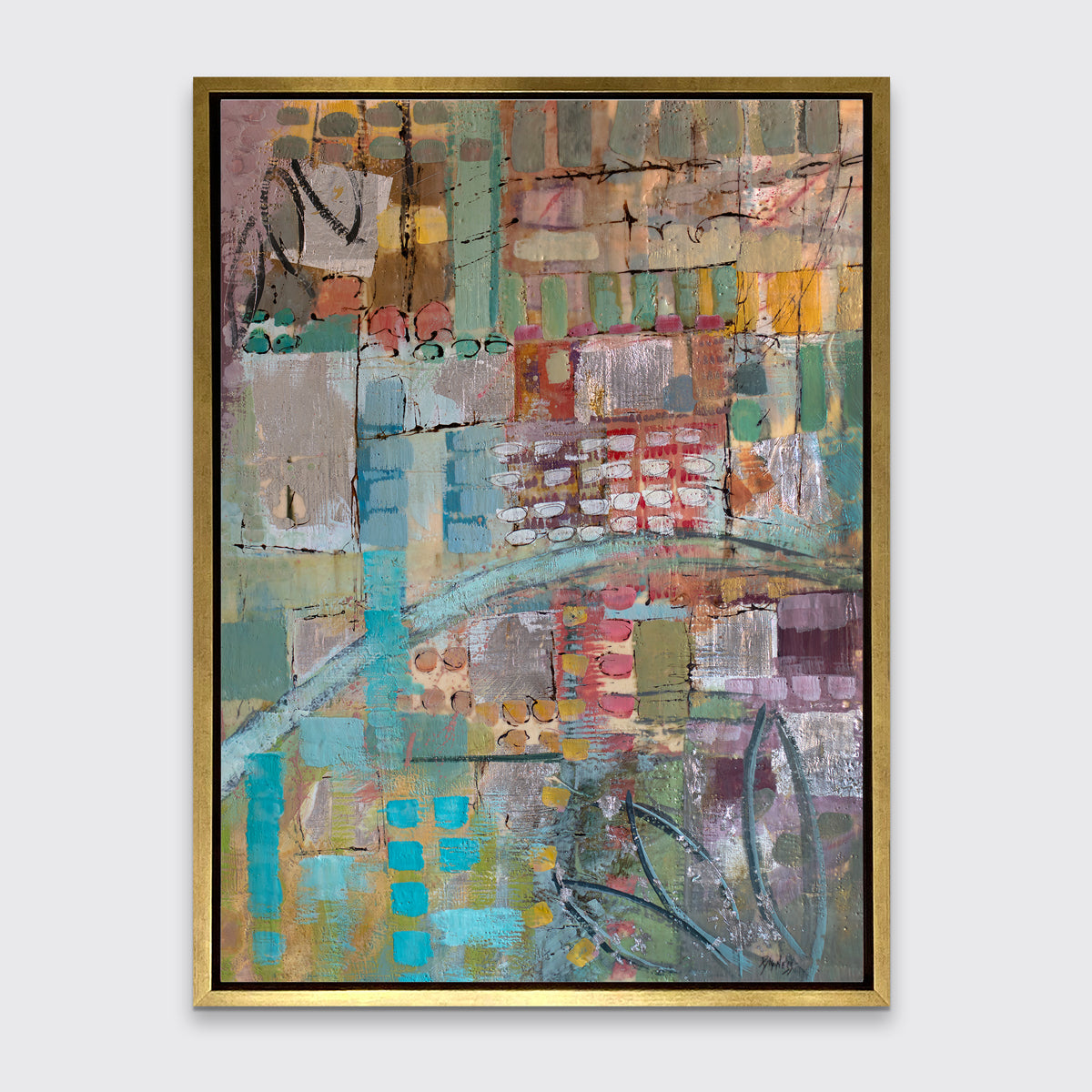 An abstract print, with green, blue, and yellow geometric and organic shapes, framed in a gold floater frame on a grey wall.