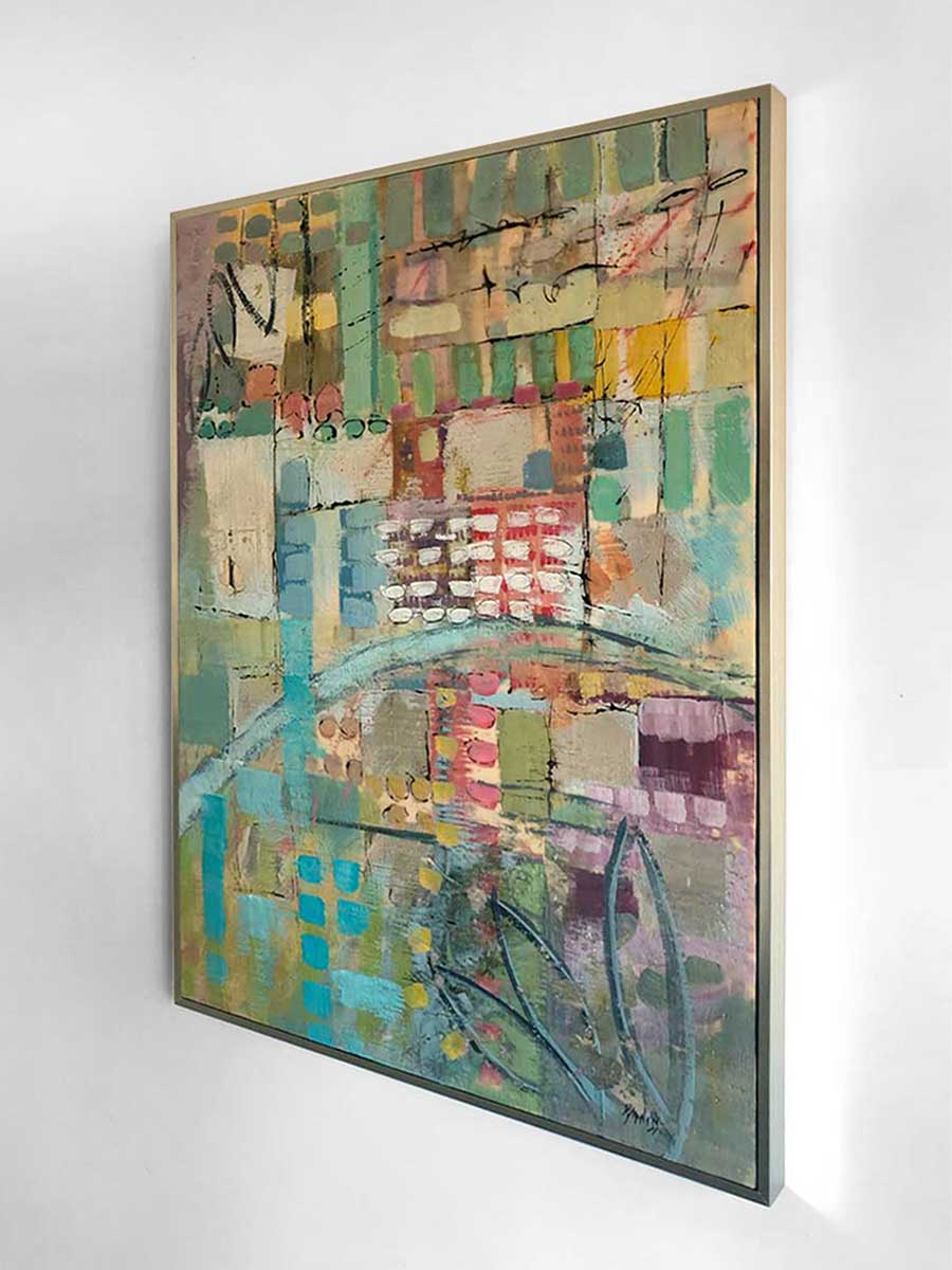 A right-hand side-angle view of an earth-toned encaustic painting, framed in a gold frame and hung on a white wall.