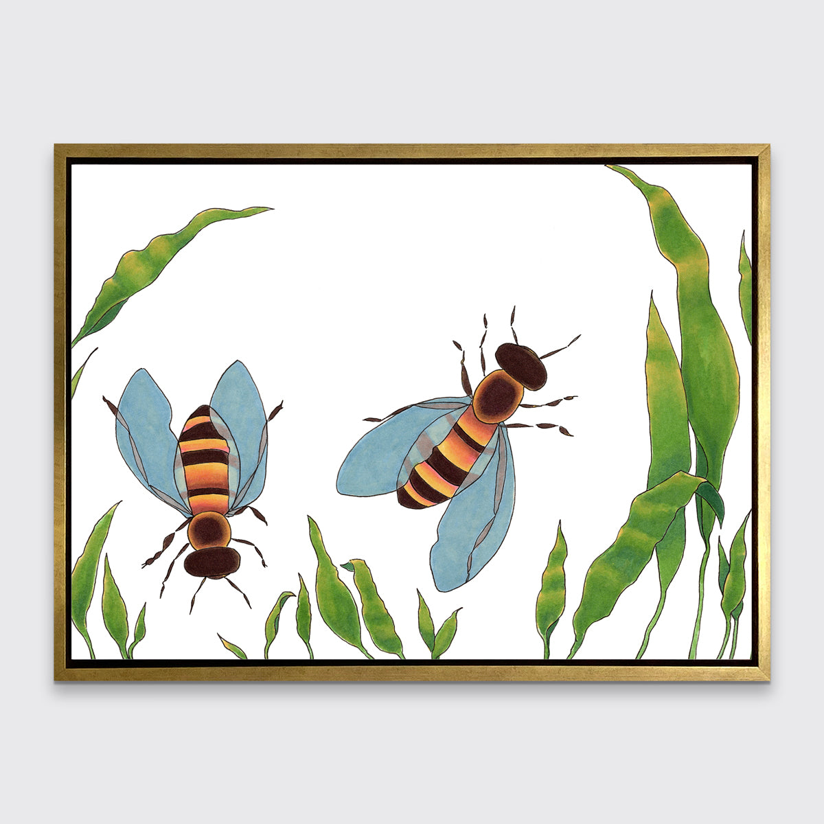 A minimalist bee illustration print framed in a gold floater frame hangs on a light grey wall.