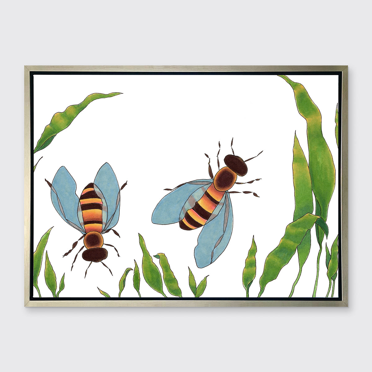 A minimalist bee illustration print framed in a silver floater frame hangs on a light grey wall.