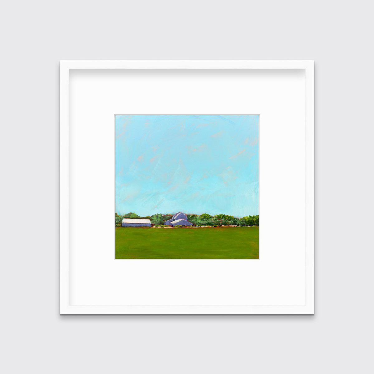 A blue, green, lavender and white landscape print in a white frame with a mat hangs on a white wall.