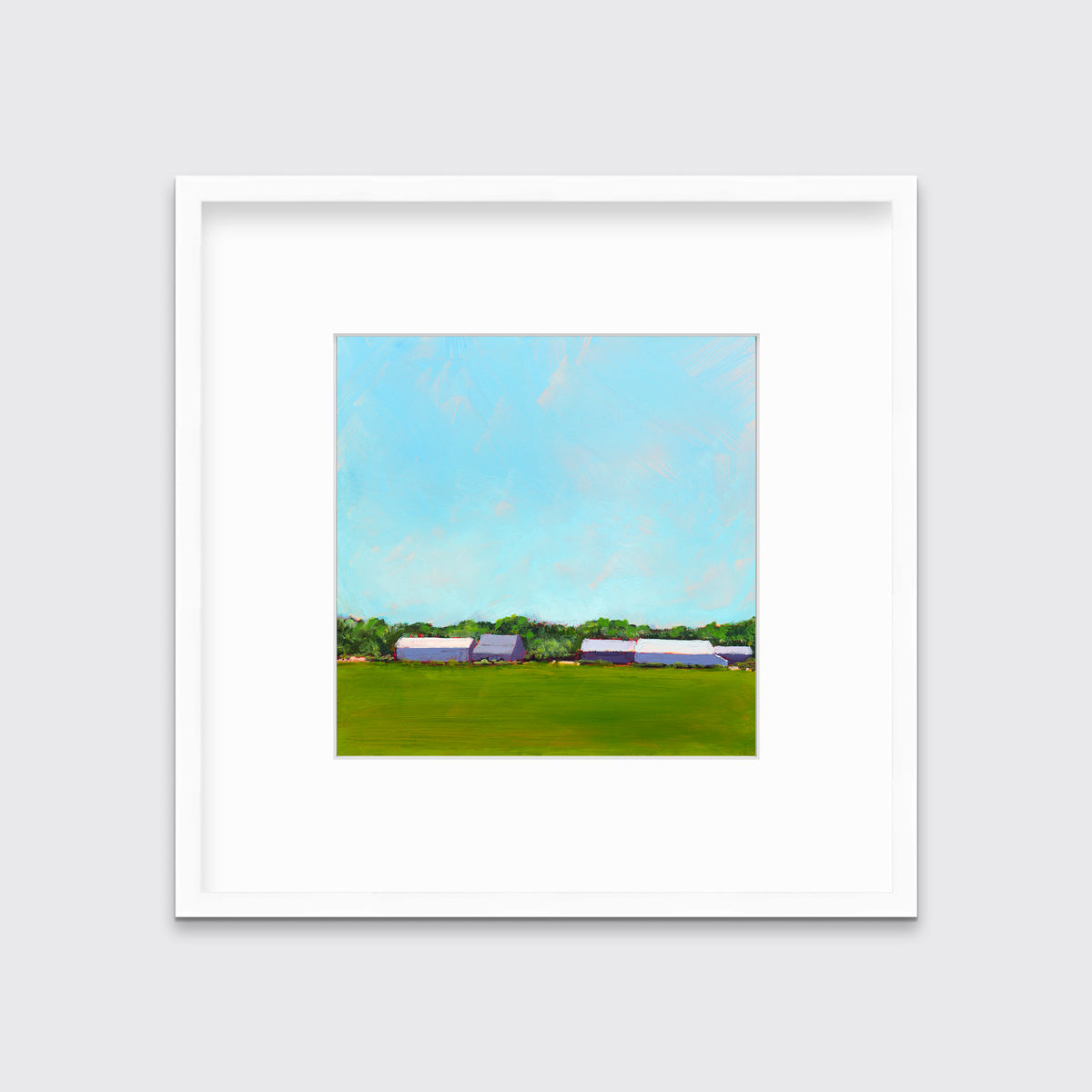 A blue, green, lavender and white landscape print in a white frame with a mat hangs on a white wall.