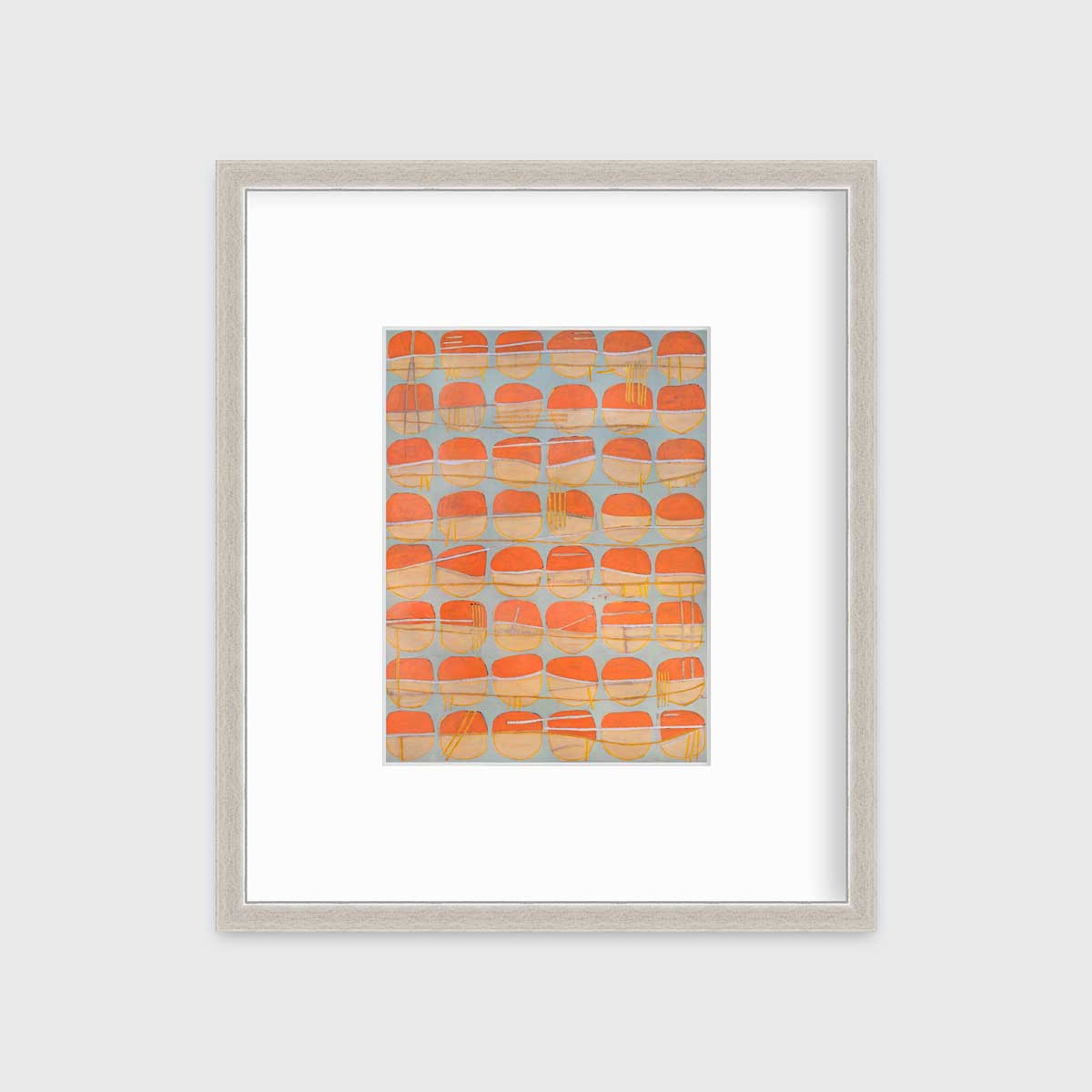 A orange, white and light blue abstract circle print in a silver frame with a mat hangs on a white wall.