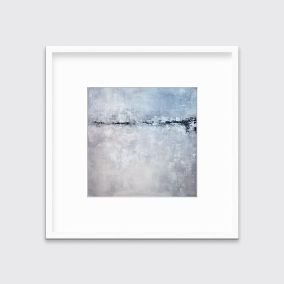 A blue and grey abstract print in a white frame with a mat hangs on a white wall.