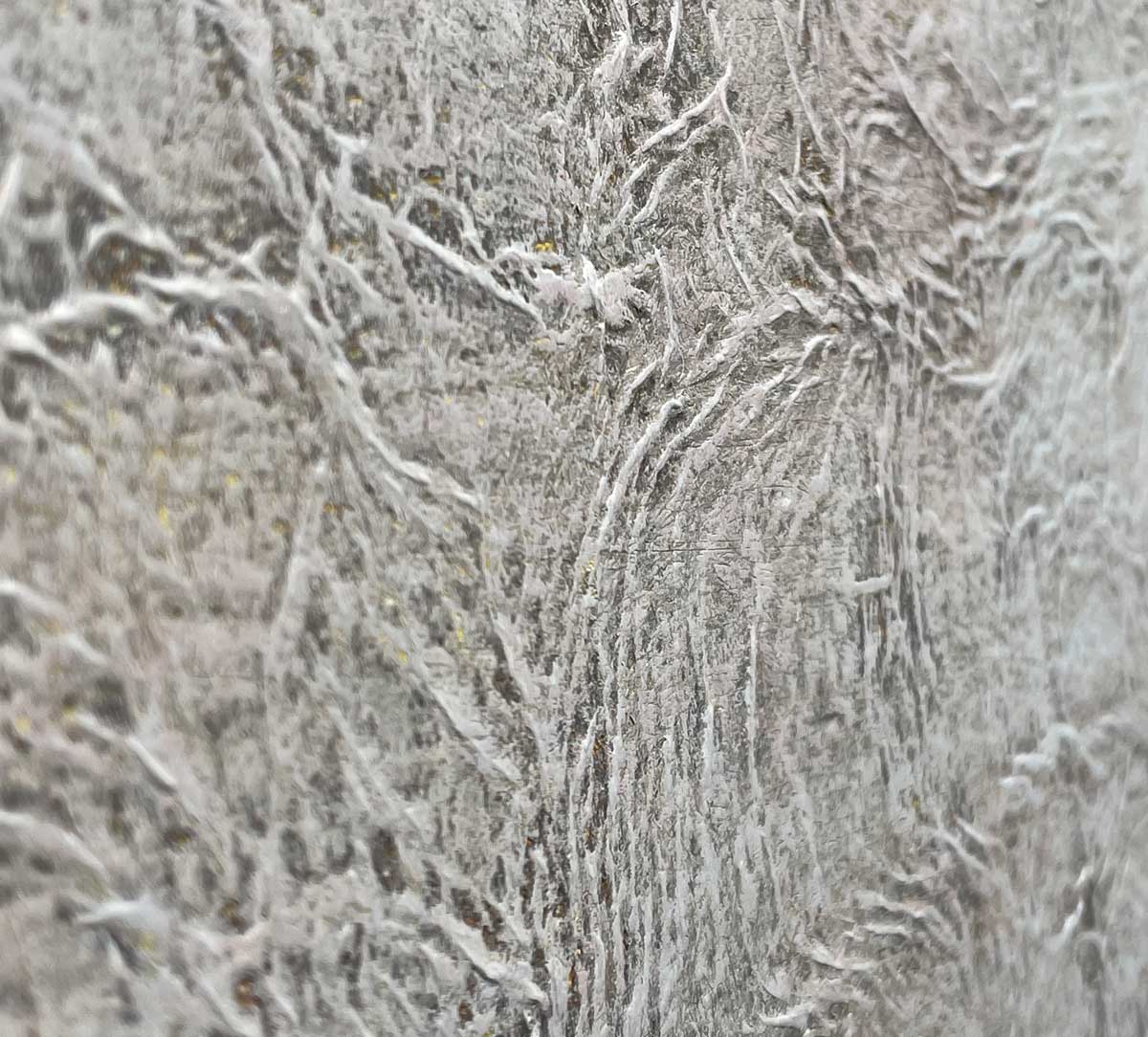 An up close view of the texture in the white and beige paint.