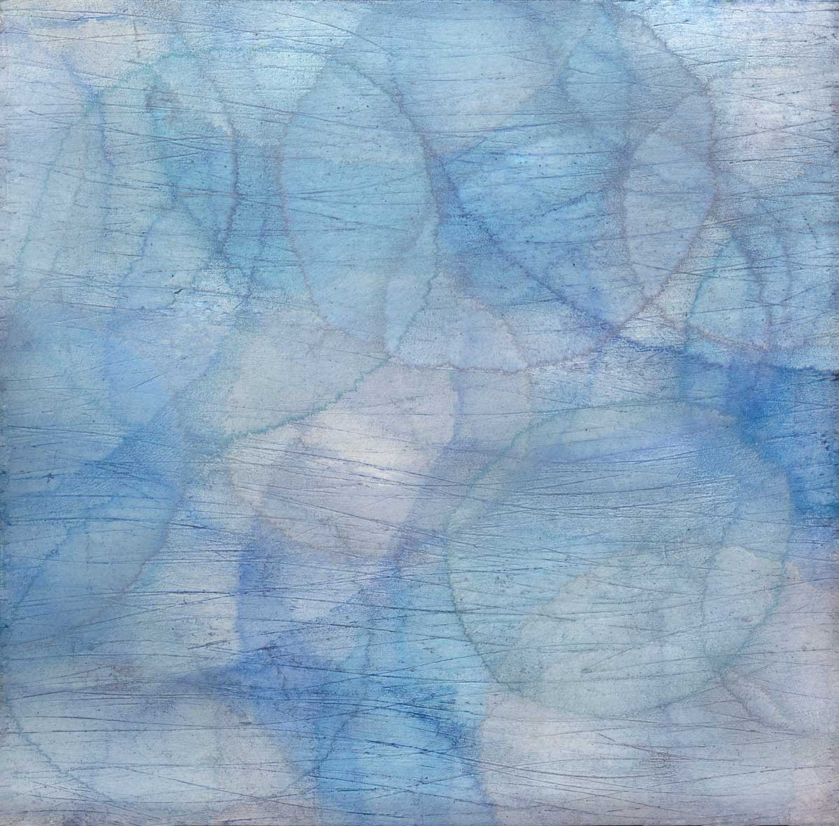 Layers of overlapping circles with an iridescent feel in blues, light purples and light greens.