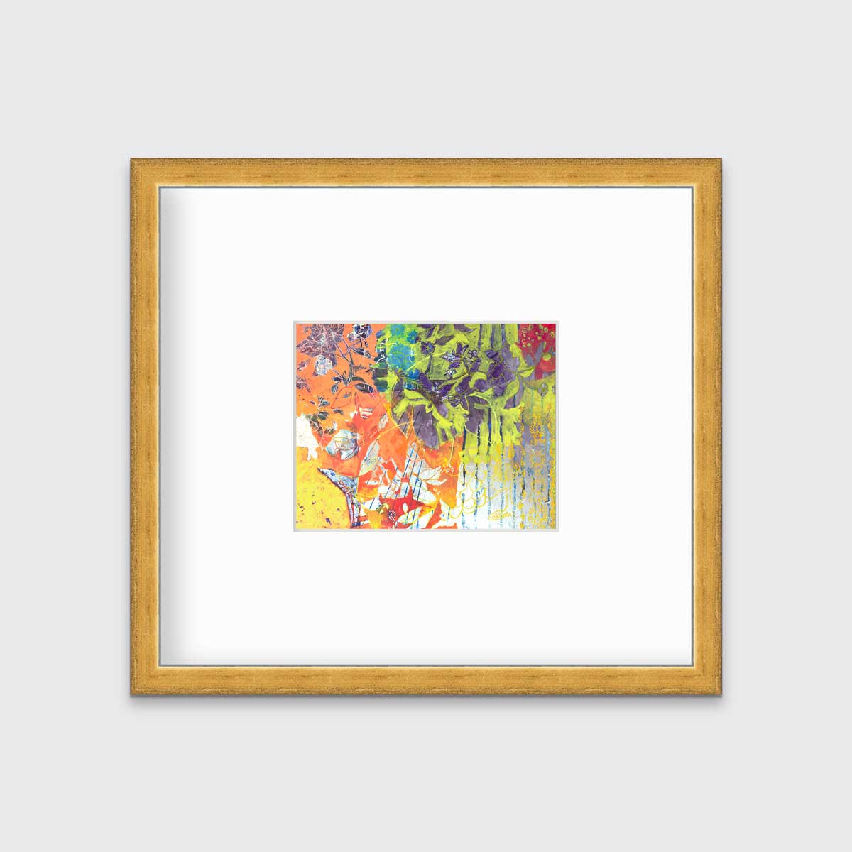 A multicolored abstract print in a gold frame with a mat hangs on a white wall.