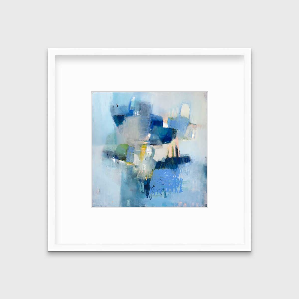 A blue abstract print by Kelly Rossetti in a white frame with a mat hangs on a white wall.