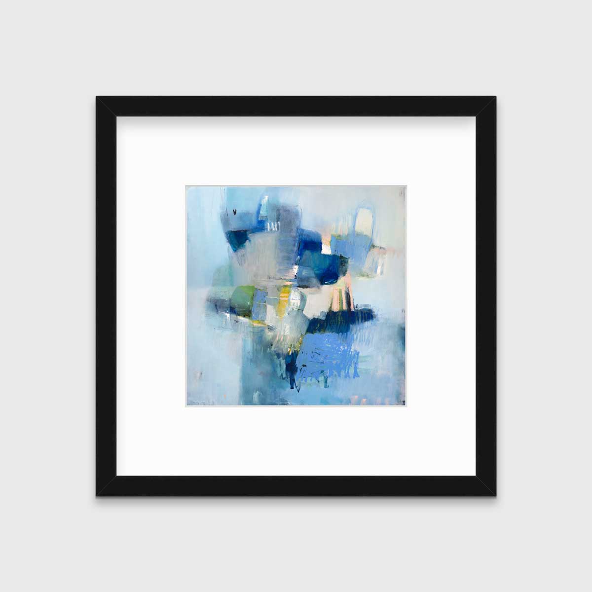 A blue abstract print by Kelly Rossetti in a black frame with a mat hangs on a white wall.
