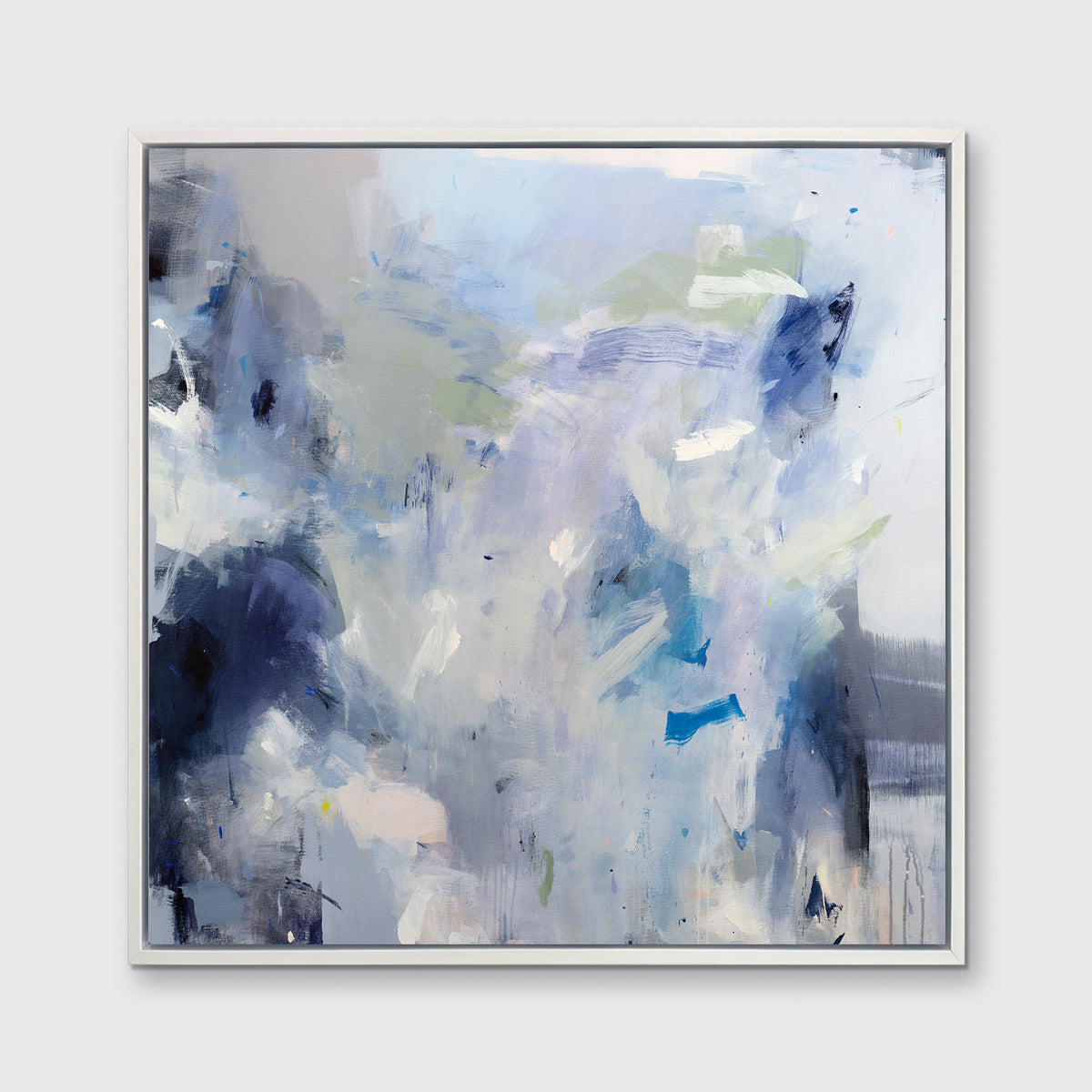 A blue, white, lavender and dark blue abstract print in a white floater frame hangs on a white wall.