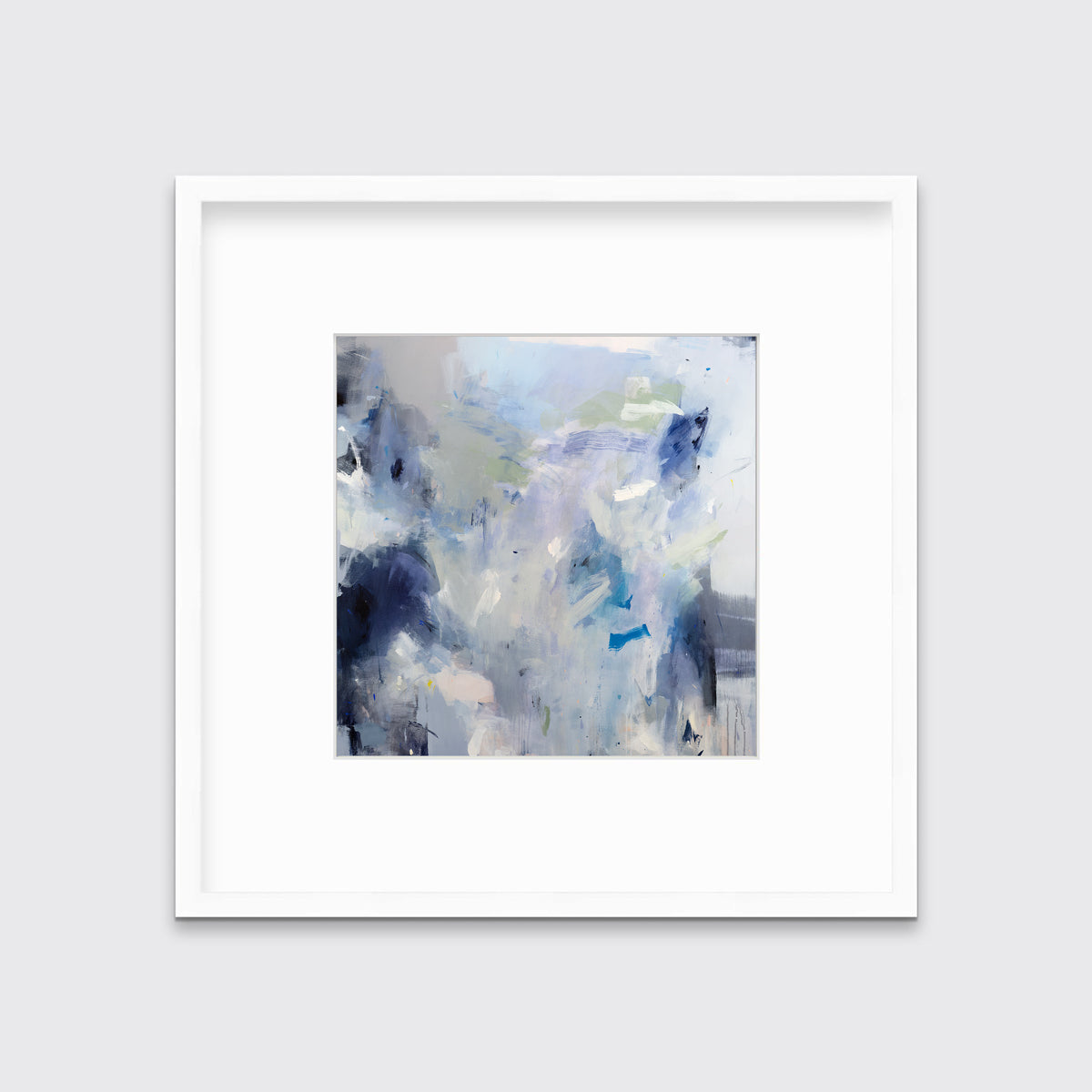 A blue, white, lavender and dark blue abstract print in a white frame with a mat hangs on a white wall.