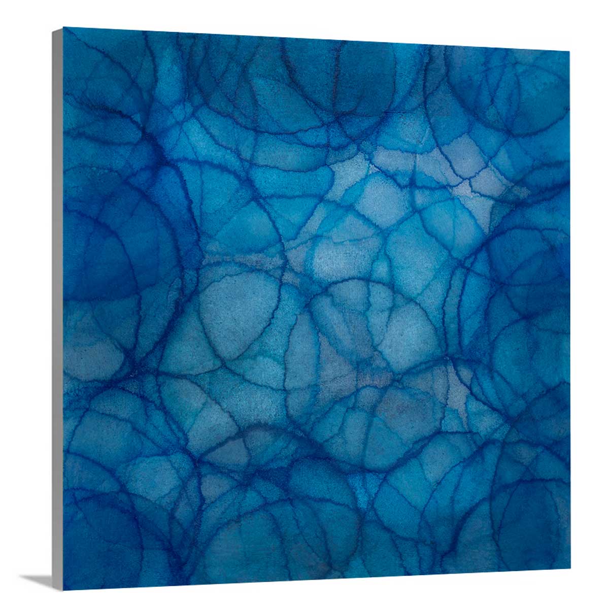 layers of overlapping circles in gradations of blue on side angle of a wrapped canvas