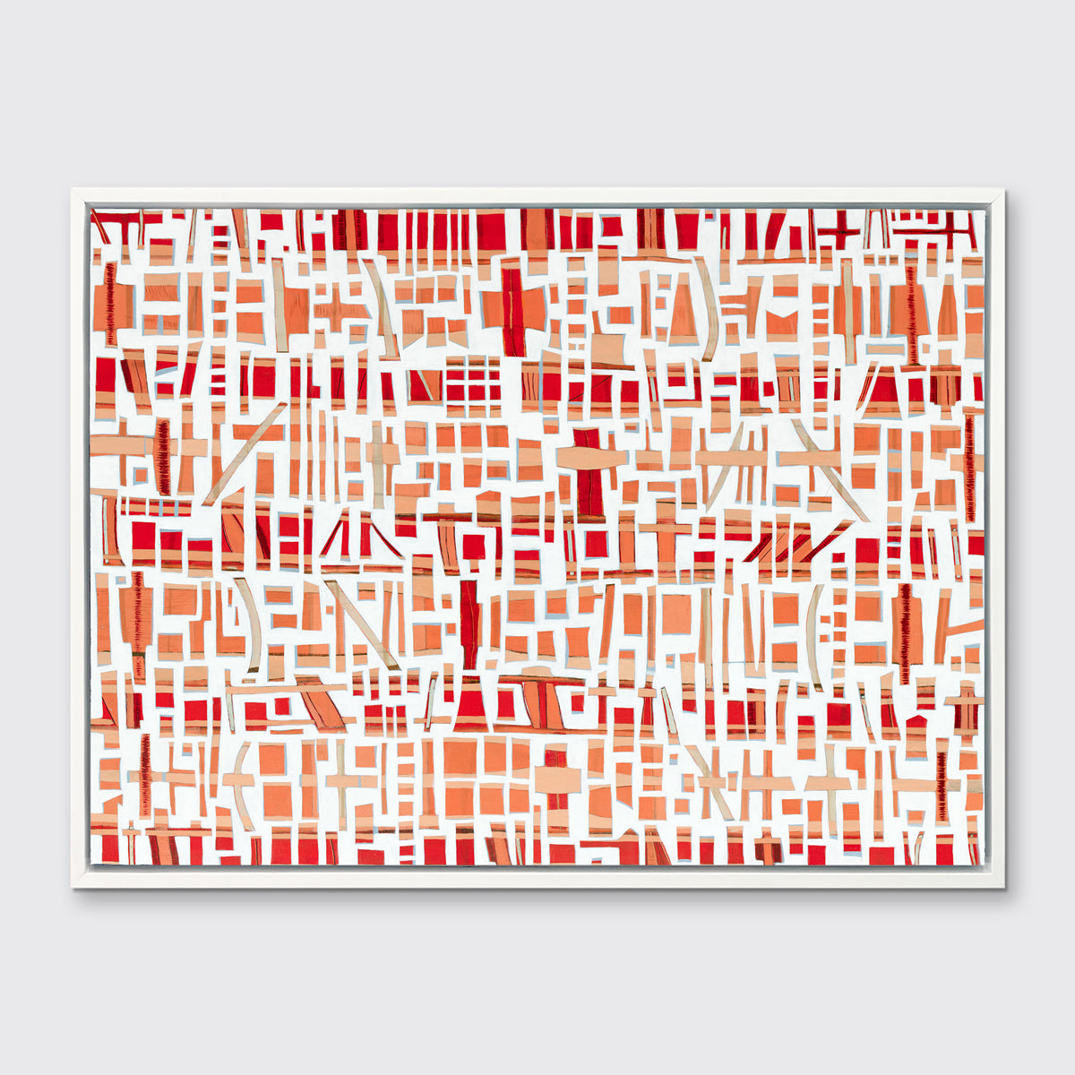 A red, white and orange abstract print in a white floater frame hangs on a white wall.