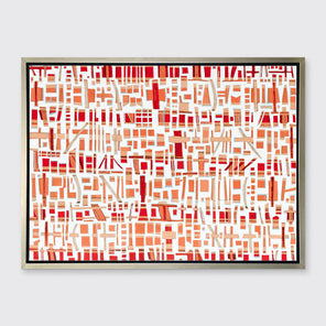 A red, white and orange abstract print in a silver floater frame hangs on a white wall.