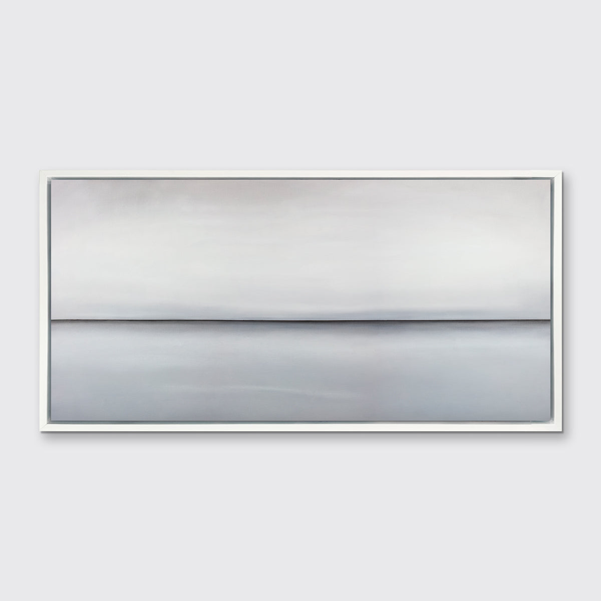 A light grey toned abstract landscape print in a white floater frame hangs on a white wall.