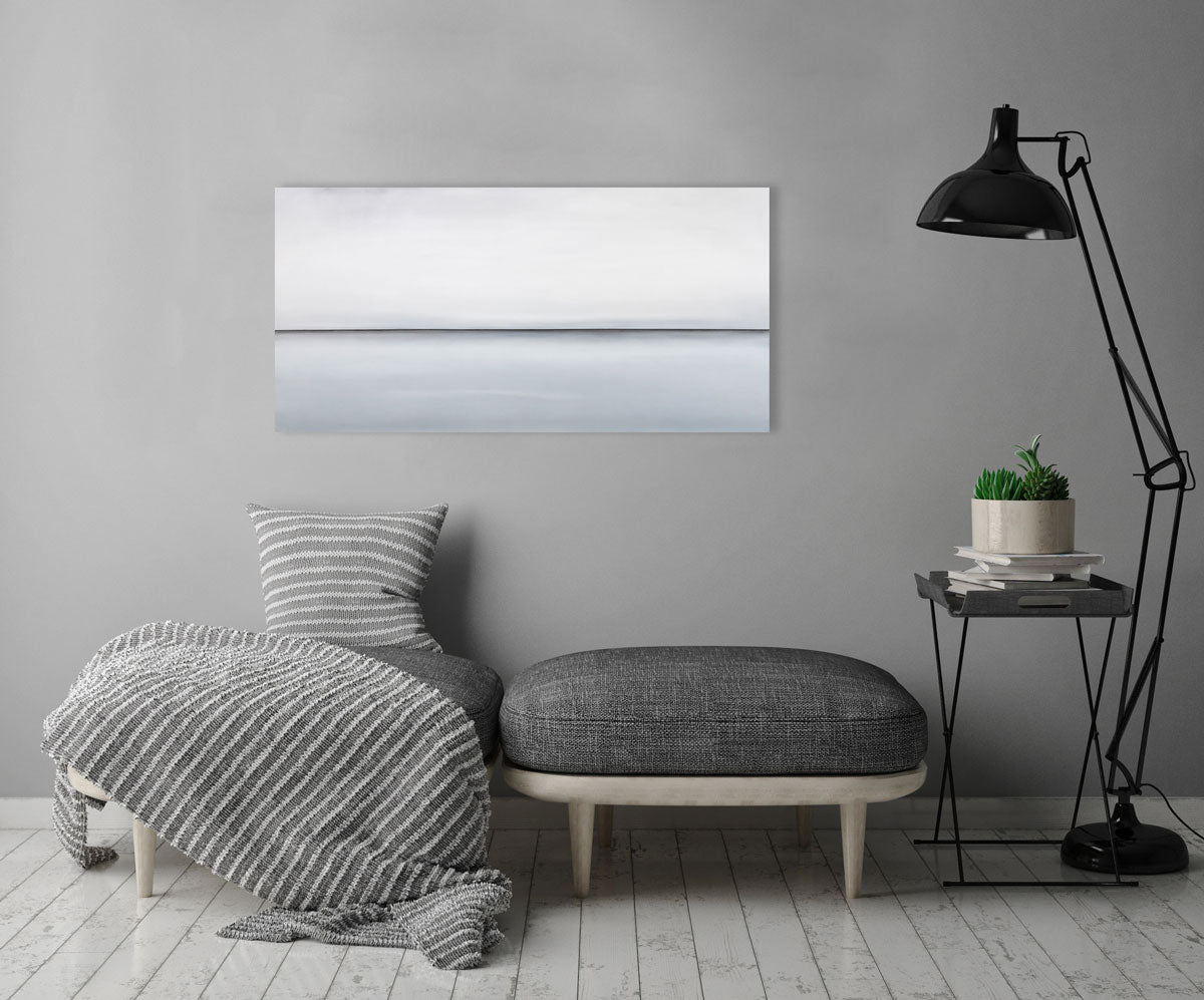 A long grey oil painting with a single black line in the middle of the canvas which suggests a horizon line is hung above two seats. Wired and ready to hang.