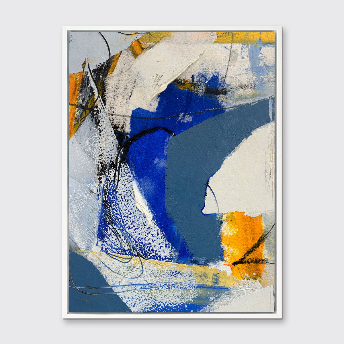 A blue, grey and yellow abstract print in a white floater frame hangs on a white wall.