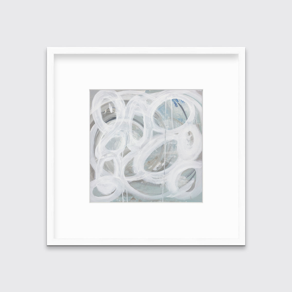 A white, light teal and grey abstract print in a white frame with a mat hangs on a white wall.