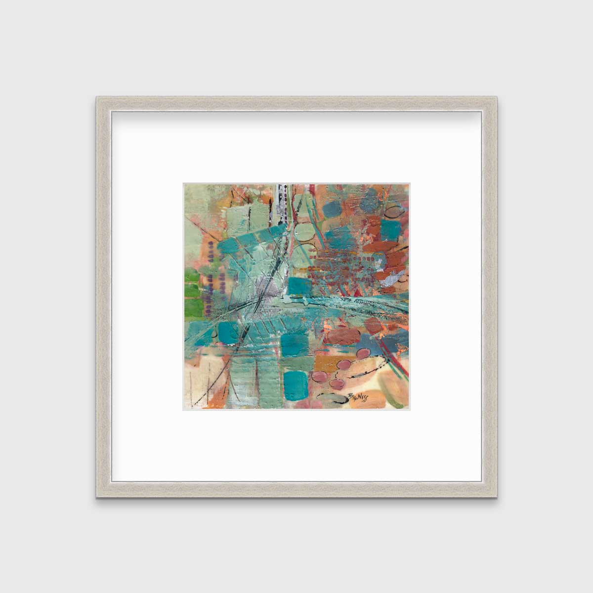 An abstract multicolored print, matted and framed in a silver frame hanging on a light grey wall.
