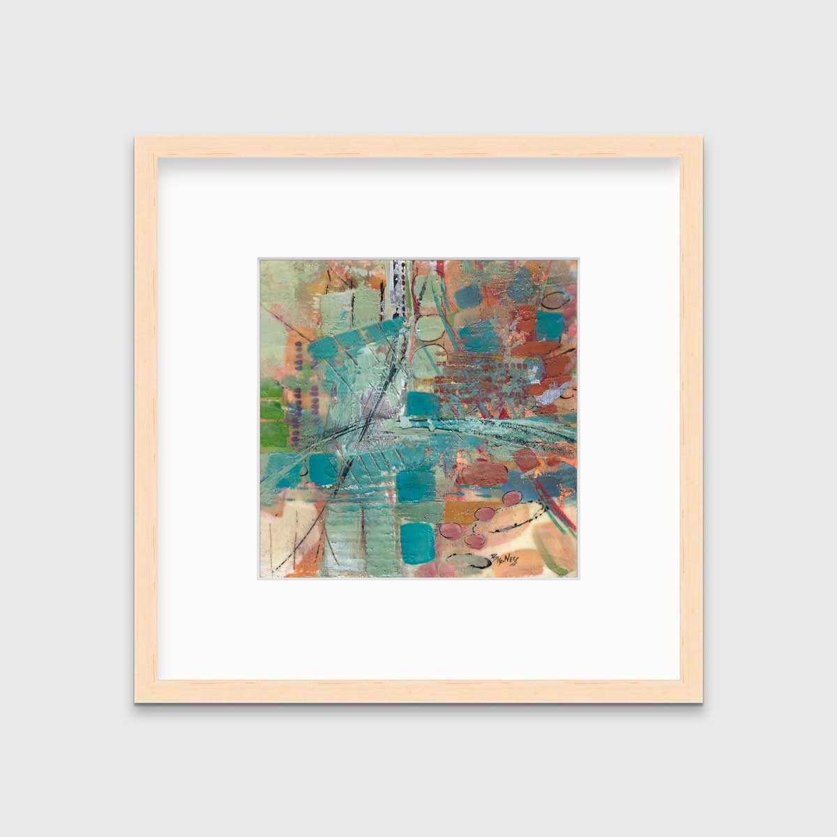 An abstract multicolored print, matted and framed in a natural wood frame hanging on a light grey wall.