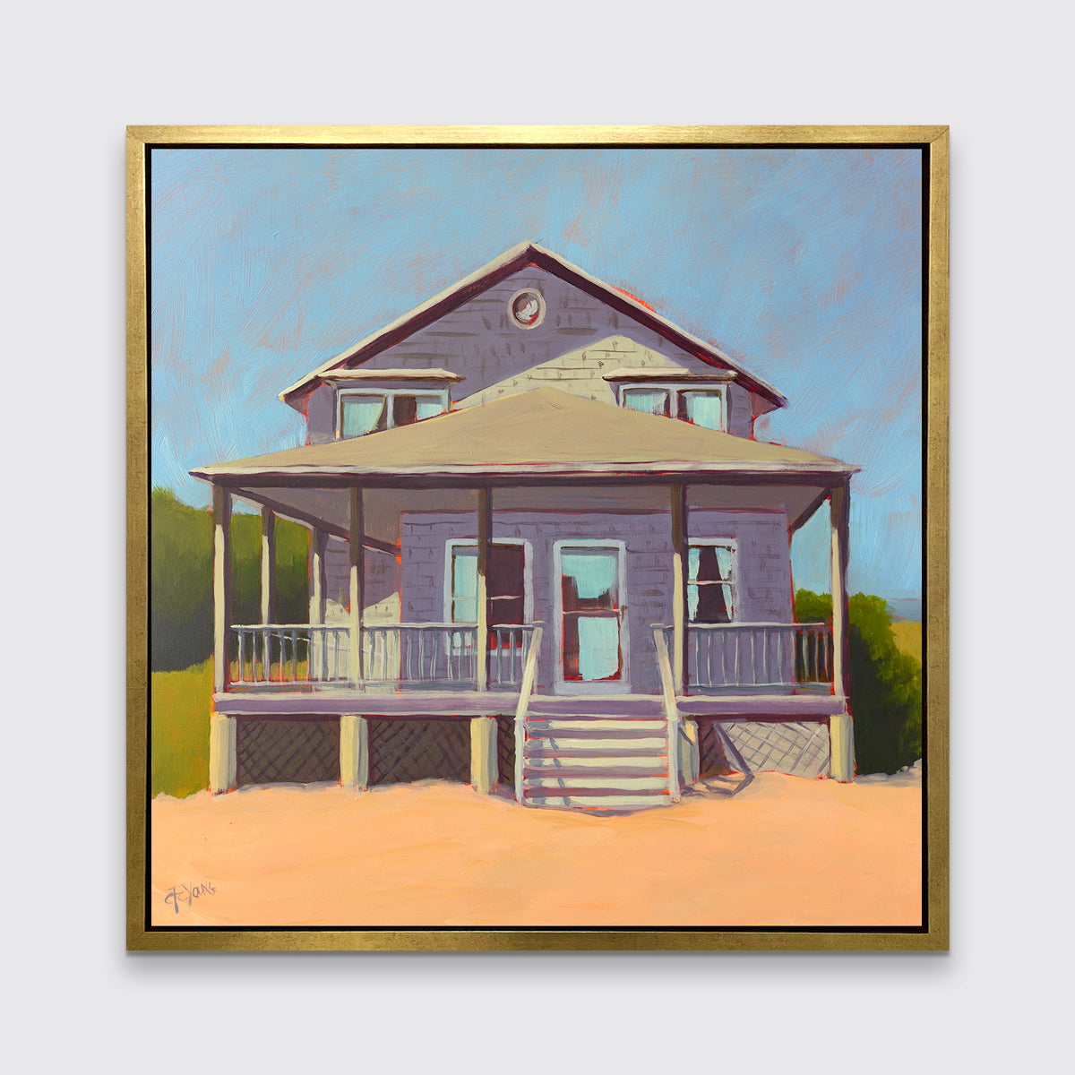 A blue, lavender and peach contemporary beach house print in a gold floater frame hangs on a white wall.
