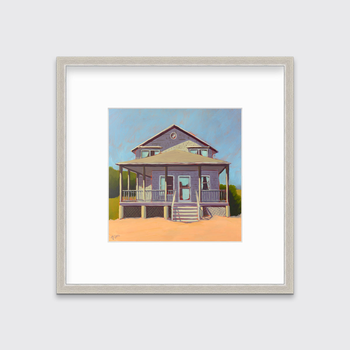 A blue, lavender and peach contemporary beach house print in a silver frame with a mat hangs on a white wall.