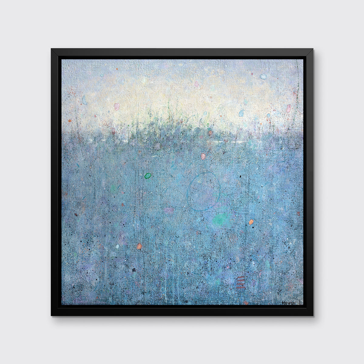 A blue abstract landscape print in a black floater frame hangs on a white wall.
