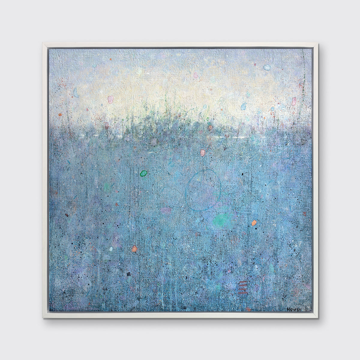 A blue abstract landscape print in a white floater frame hangs on a white wall.