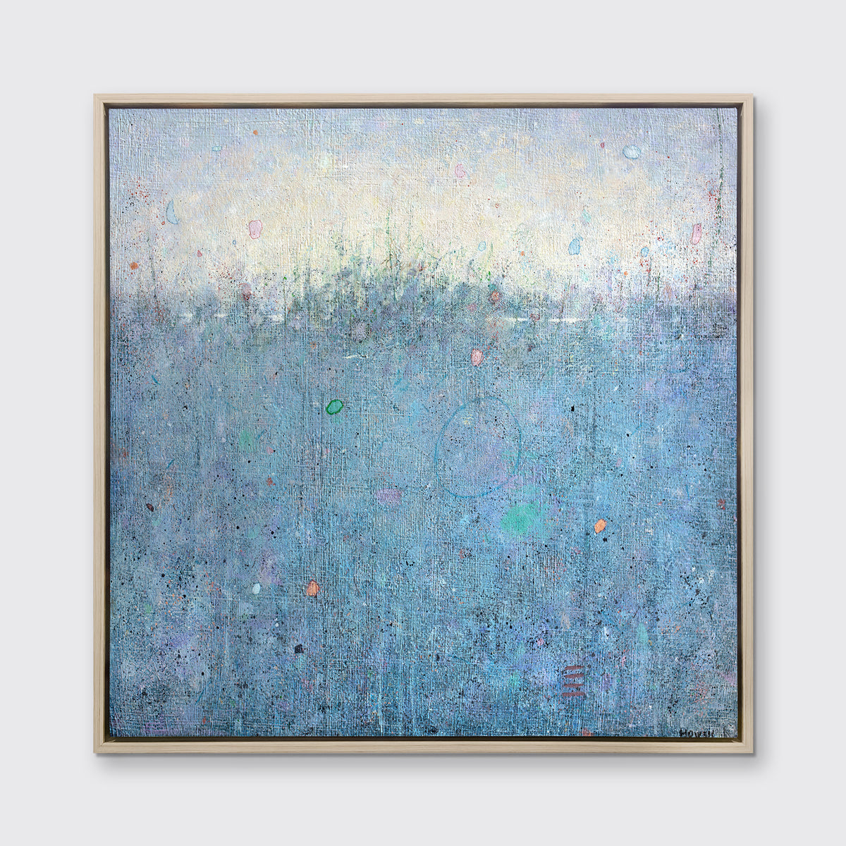 A blue abstract landscape print in a white oak wood floater frame hangs on a white wall.