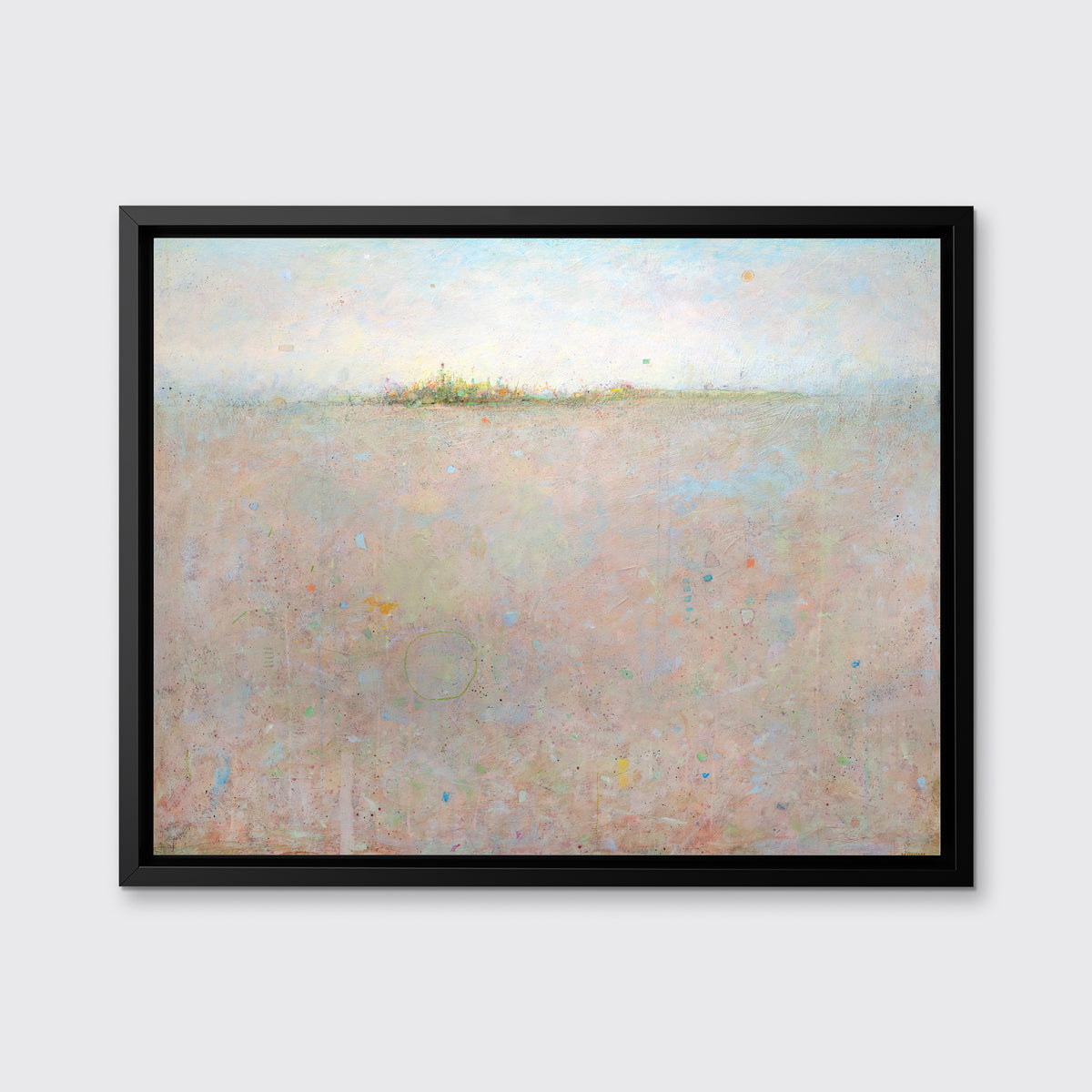 A peach and blue abstract landscape print in a black floater frame hang on a white wall.
