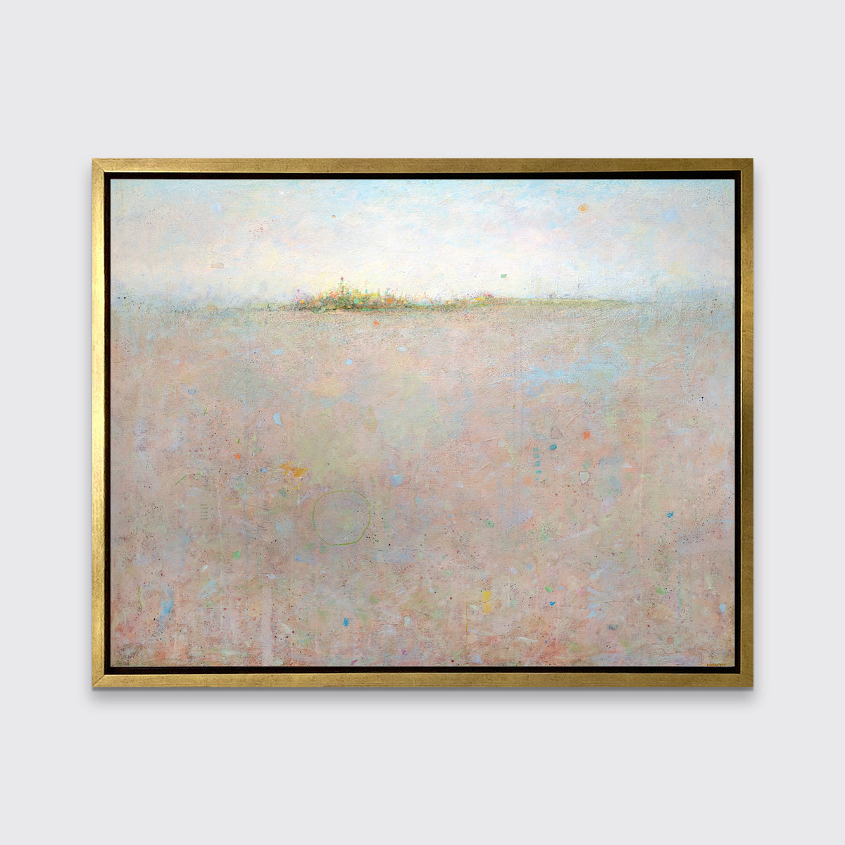A peach and blue abstract landscape print in a gold floater frame hangs on a white wall.