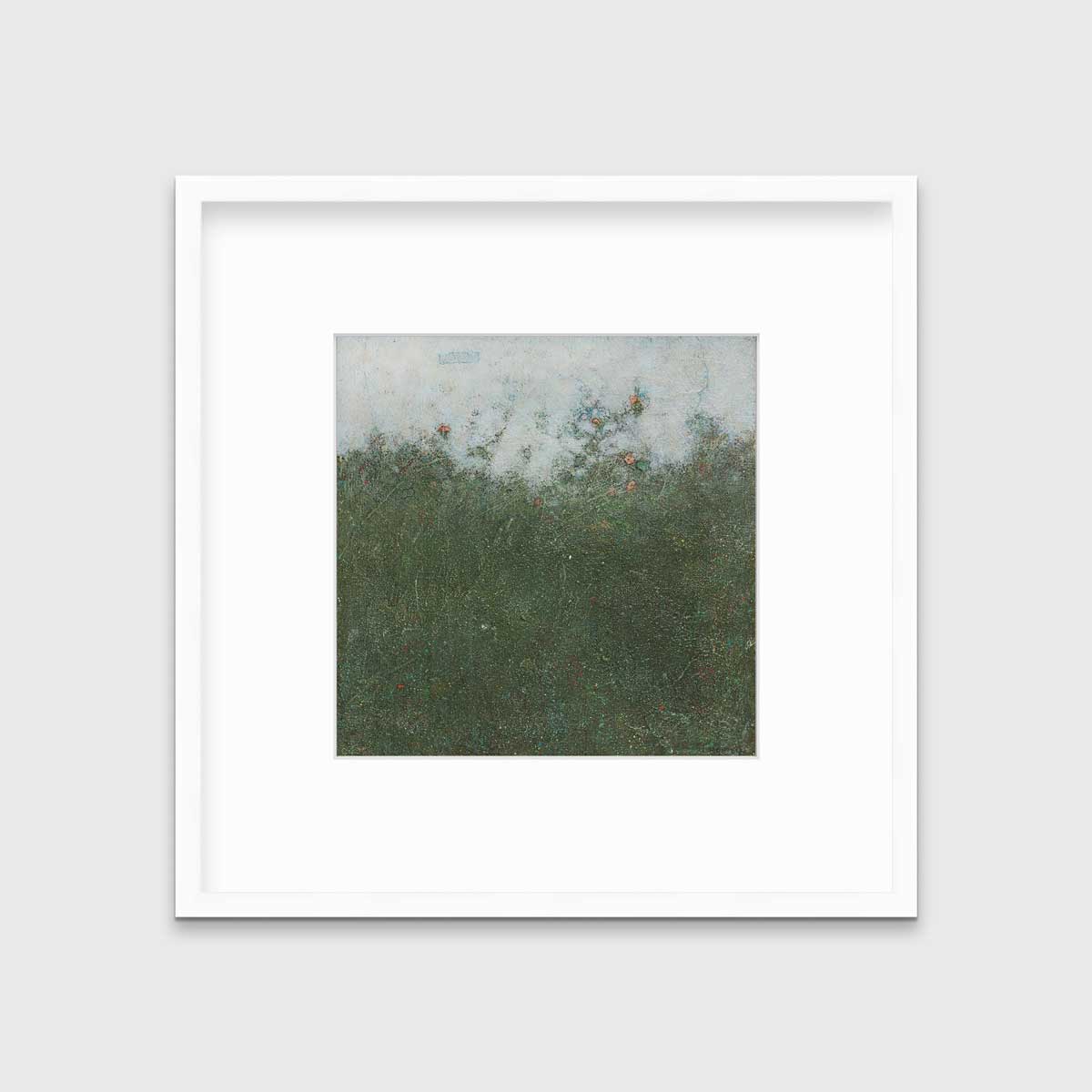 A dark green abstract landscape print in a white frame with a mat hangs on a white wall.